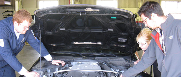 students working on car